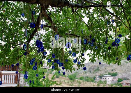 Blaue, böse Augenperlen hingen an einem Baum Stockfoto