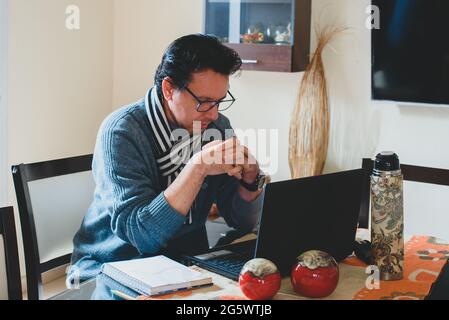 Hombre escribiendo en la mesa de madera planificando el analisis de negocio con la Laptop, venta,compra, Internet desde casa. Stockfoto