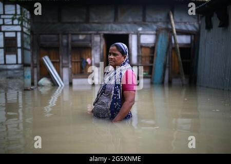 Am 28. Juli 2020 wird eine Frau in Munshiganj, in der Nähe von Dhaka, Bangladesch, überflutet gesehen. Mehr als 9.6 Millionen Menschen sind von Monsunfluten betroffen, die große Teile Indiens, Bangladeschs und Nepals erschütternd erschütternd ausgenutzt haben. Stockfoto