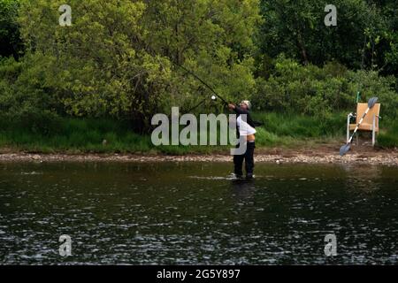 Loch Venachar, Loch. Lomonnd und Trossachs National Park, Schottland, Großbritannien. 30. Juni 2021. IM BILD: Ein schwarzer ethnischer Mann wird an einem heißen und sonnigen Abend auf dem loch gesehen, wie er seine Angelrute in den loch wirft, während er Musik über seine Kopfhörer hört. Quelle: Colin Fisher/Alamy Live News Stockfoto