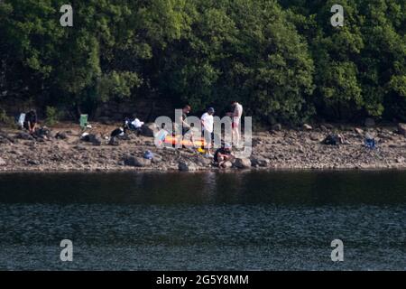 Loch Venachar, Loch. Lomonnd und Trossachs National Park, Schottland, Großbritannien. 30. Juni 2021. IM BILD: Leute auf dem Wasser paddeln, Kajakfahren, wildes Schwimmen und genießen das heiße Sommerwetter während einer Zeit, in der die schottischen Seen von Wasser erschöpft sind. Der große steinerne Strand liegt um den loch herum, der normalerweise komplett unter Wasser wäre, aber bei dem langen trockenen und heißen Wetter gibt es nichts, was das verdunstende Wasser ersetzen könnte. Quelle: Colin Fisher/Alamy Live News Stockfoto