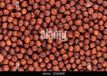 Braune Kichererbsen Hintergrund. Rote Kichererbsen. Garbanzo, bengalgram oder Kichererbsen. Stockfoto