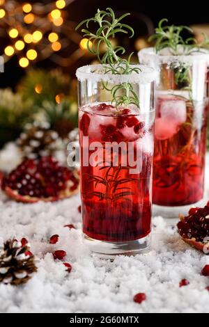 Glas mit Granatapfel Margarita mit kandierten Preiselbeeren, Rosmarin. Perfekter Cocktail für eine Weihnachtsfeier Stockfoto