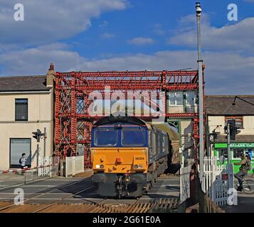 Ein Network Rail-Ingenieur fährt von Carlisle nach Crewe am Bahnübergang Bamber Bridge in Lancashire vorbei, der von der DRS-Diesellokomotive Nr. 66304 gezogen wird. Stockfoto