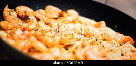 Appetitliche Garnelen mit Rahm und Must in einer Pfanne Stockfoto