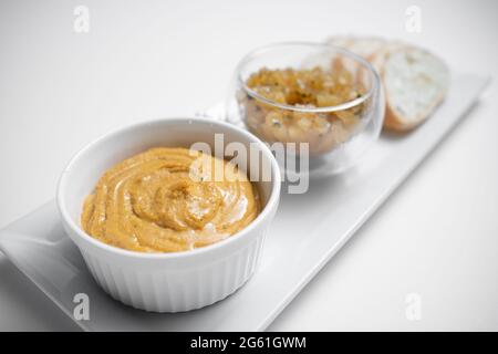 Nahaufnahme von Gänseleber-Pastete mit Apfelchutneys und Brot auf weißem Hintergrund Stockfoto