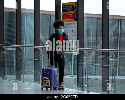 Medellin, Antioquia, Kolumbien - 17 2021. Mai: Latina mit Maske wartet mit ihrer Tasche am Flughafen Jose Maria Cordova Stockfoto