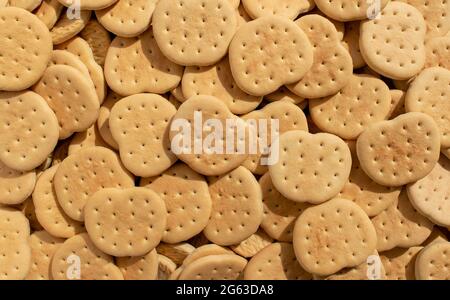 Hintergrund aus vielen einfachen Cookies. Kleine leckere Cracker. Stockfoto