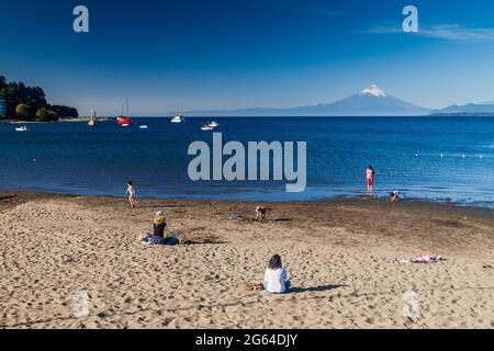 PUERTO VARAS, CHILE - MÄR 23: Menschen an einem bach des Llanquihue-Sees in Puerto Varas. Vulkan Osorno im Hintergrund, Chile Stockfoto