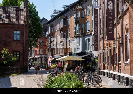 Odense, Dänemark - 9. Juni 2021: Blick auf die malerische und geschäftige Altstadt von Odense mit vielen Geschäften und Menschen Stockfoto