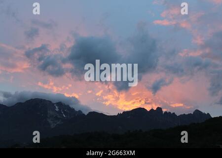 Wolken am Himmel mit einem Berg im Hintergrund Stockfoto