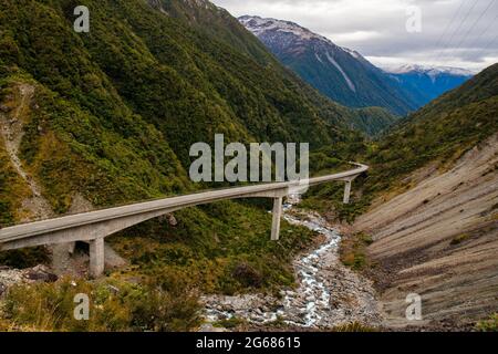 Autobahn durch die Berge auf dem Arthurs Pass Viadukt, der sich durch die zerklüftete Otira Gorge schlängelt Stockfoto