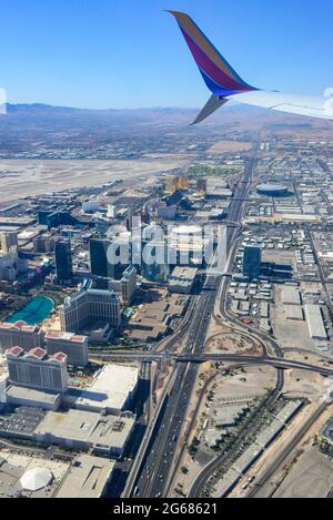 Ein Düsenflügel eines 780 Max-Flugzeugs im Vordergrund einer Luftaufnahme der Interstate 15 und des Vegas Strip-Bereichs kurz nach dem Start von Las Vegas Stockfoto