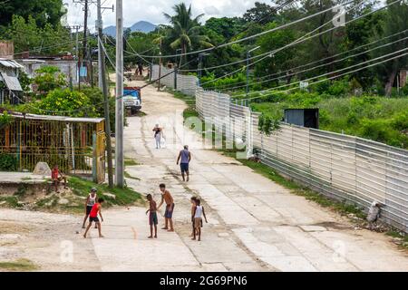 Lebensstil kubanischer Kinder, die in einer Stadtstraße in Santiago de Cuba, Kuba, ohne Schutzmaske spielen Stockfoto