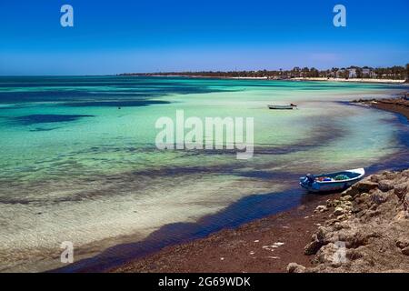 Herrliche Aussicht auf die Mittelmeerküste mit Birkenwasser, weißem Sandstrand und einem Fischerboot Stockfoto