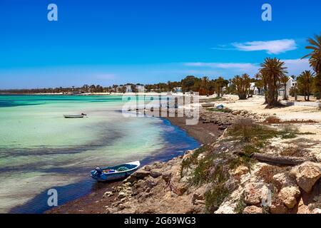 Herrliche Aussicht auf die Mittelmeerküste mit Birkenwasser, weißem Sandstrand und einem Fischerboot Stockfoto