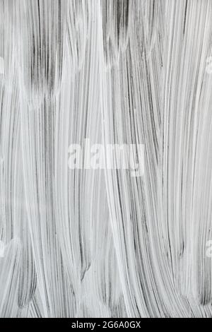 Weiße Malstriche auf einem Schaufenster, abstrakter Hintergrund oder Textur Stockfoto