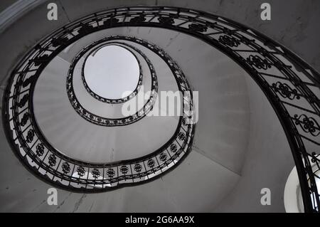 Rijeka, Kroatien Mai 2021.Wendeltreppe.Design Wendeltreppe in einem alten Gebäude, kreisförmige architektonische Form. Schwarz-Weiß-Foto von altem Spitzspieß Stockfoto