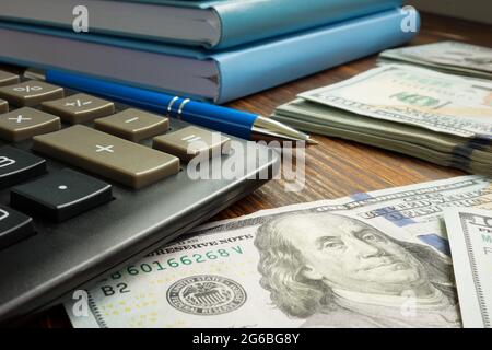 Persönliche Ersparnisse und Finanzen. Rechner und Geld auf dem Tisch. Stockfoto