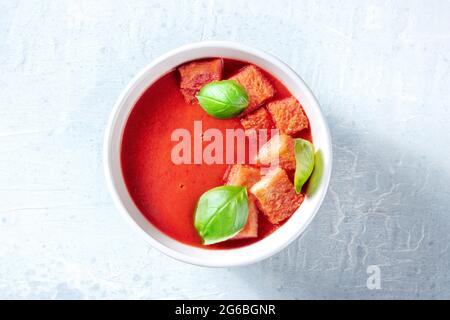 Tomatensuppe mit Basilikum, gesunde vegane Detox-Schale, Top Shot. Frühlingsmittagessen Stockfoto