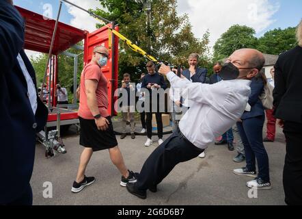 Hannover, Deutschland. Juli 2021. Olaf Scholz (SPD), SPD-Kanzlerkandidat und Bundesfinanzminister, trainiert auf einem mobilen Sportcontainer beim Volunteer-Festival des Turn Klubb zu Hannover. Quelle: Julian Stratenschulte/dpa/Alamy Live News Stockfoto