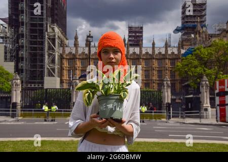 London, Großbritannien. Juli 2021. Ein Protestler hält eine Pflanze mit der Aufschrift „Save the Planet“ auf der Seite des Topfes beim „Kill the Bill“-Protest. Demonstranten versammelten sich auf dem Parliament Square, um gegen das Gesetz über Polizei, Kriminalität, Verurteilung und Gerichte zu protestieren, von dem viele sagen, dass es der Polizei mehr Macht über Proteste in Großbritannien geben würde. (Kredit: Vuk Valcic / Alamy Live News) Stockfoto