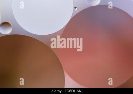 Rote und violette Blasen, die durch Öl in Wasser gebildet werden. Stockfoto