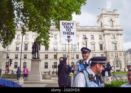 London, Großbritannien. Juli 2021. Polizeibeamte lachen, als ein Demonstrator ihnen mit einem Schild mit der Aufschrift „Rede nicht mit ihnen“ während des Protestes zum Töten des Gesetzentwurfs folgt. Demonstranten versammelten sich auf dem Parliament Square, um gegen das Gesetz über Polizei, Kriminalität, Verurteilung und Gerichte zu protestieren, von dem viele sagen, dass es der Polizei mehr Macht über Proteste in Großbritannien geben würde. (Foto: Vuk Valcic/SOPA Images/Sipa USA) Quelle: SIPA USA/Alamy Live News Stockfoto