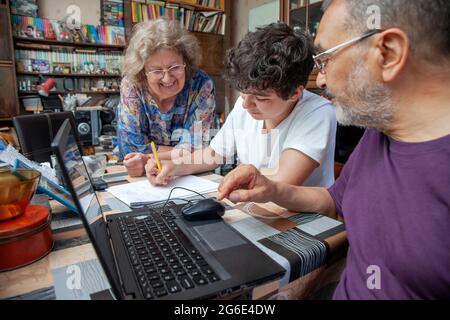 Teenage Boy nimmt Math-Lektionen von Großeltern zu Hause Stockfoto