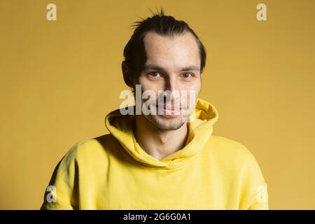 Portrait lächelnder Mann im gelben Kapuzenpullover Stockfoto