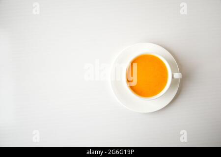 Kürbis-Smoothie, Gewürzlatte. Alkoholiger Cocktail in weißer Tasse auf weißem Hintergrund. Heiße Getränke der Herbstsaison. Erntedankfest. Draufsicht Stockfoto