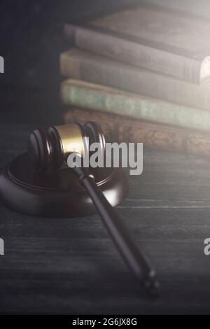 Hölzerne Richter gavel auf einem Schreibtisch mit Büchern im Hintergrund Stockfoto