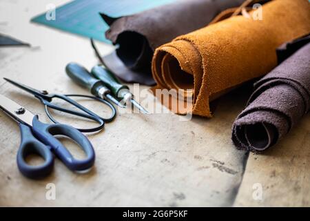 Draufsicht Holztisch Oberfläche Copyspace mit Materialien, Instrumente. Lederwerkstatt Stockfoto