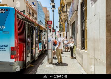 Valencia, Spanien. Juli 2021. An einer Bushaltestelle warten die Leute auf den Bus. Die Stadtverkehrsgesellschaft (Empresa Municipal de Transportes, EMT) von Valencia hat das Durchschnittsalter ihrer Flotte von 13 Jahren im Jahr 2015 auf 7.3 Jahre reduziert, was auf die Aufnahme der letzten 164 neuen Hybridbusse zurückzuführen ist. Kredit: SOPA Images Limited/Alamy Live Nachrichten Stockfoto