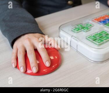 Frau mit zerebraler Lähmung, die an einer speziellen drahtlosen Computermaus arbeitet. Stockfoto
