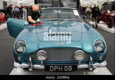 Chris Bailey, Leiter der Fahrzeugpräsentation bei Bonhams, reinigt ein 1964 Aston Martin DB5-Cabriolet, das im Bonhams Saleroom im Goodwood Estate, Chichester, West Sussex, das zuvor Prinzessin Margaret und Lord Snowdon gehörte, und dem Schauspieler Peter Sellers ausgestellt wird. Und wird geschätzt, £1.3-1.5 Millionen in der Bonhams Festival of Speed Sale am Freitag zu holen. Bilddatum: Donnerstag, 8. Juli 2021. Stockfoto
