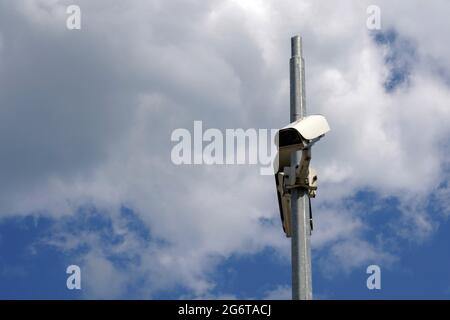 CCTV-Kamera an einem Metallmast mit Himmel auf dem Hintergrund und viel Platz für Kopien befestigt. Es dient dem Schutz des Eigentums für beide Privatpersonen Stockfoto