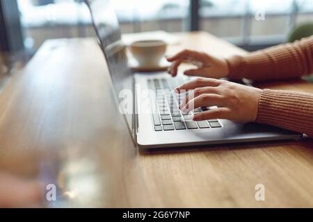 Freiberuflerin mit kabellosem Laptop im Café Stockfoto