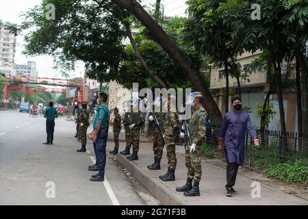 Dhaka, Bangladesch. Juli 2021. Armee- und Polizeibeamte stehen an einem Kontrollposten, während sie Passagiere während einer Sperre überprüfen. Die Regierung von Bangladesch hat ihre strikte Sperre mit Aufenthaltsbefehlen für Bürger bis zum 14. Juli verlängert, da die täglichen Todesfälle durch Coronaviren ein Rekordhoch erreichten. Stockfoto