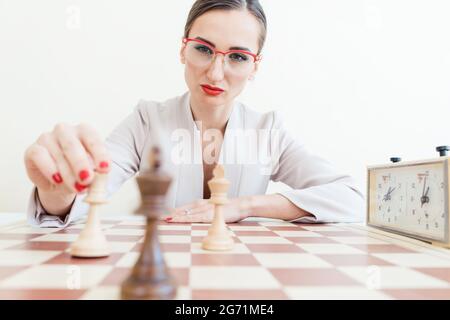 Geschäftsfrau, die strategischen Schritt im Schachspiel macht Stockfoto