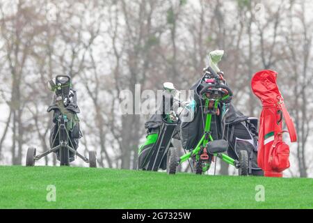 Golfschläger in einer Tasche auf einem Wagen auf einem Golfplatz. Stockfoto