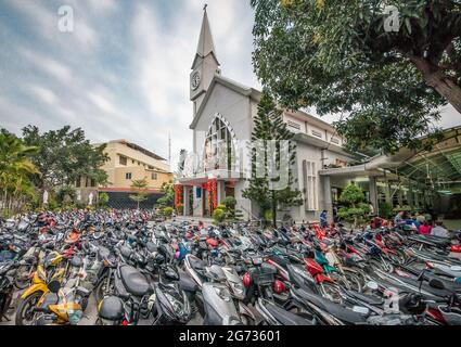 Hunderte von Motorrädern vor einer Kirche in vietnam Stockfoto