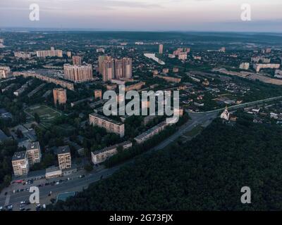 Luftaufnahme am Morgen Kharkiv Stadt Pavlove Pole Bezirk Derevianka St. mehrstöckige Gebäude neue Wohngegend in der Nähe von Wald im Sommer Dämmerung Licht Stockfoto