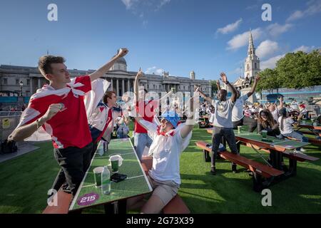 EURO 2020: England gegen Dänemark. Die Anhänger Englands sehen sich die großen Leinwände am Trafalgar Square an, während England Dänemark für das Halbfinale antritt. London, Großbritannien Stockfoto