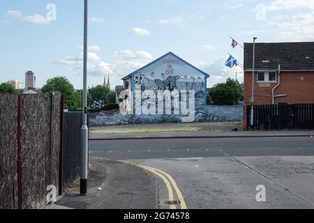 Das Wandgemälde von ìSummer 69î bei Hopewell Crescent an der Crumlin Road im Shankil Estate, Das zeigt die Verwüstung, die sich im Sommer 1969.Communities ereignete, auf beiden Seiten befürchten sie eine Rückkehr zu einem volatilen Zustand im Norden aufgrund neuer Spannungen infolge der Post-Brexit-Protokolle. Vorbereitungen anstelle der Lagerfeuernacht am 11. Juli in Belfast vor den jährlichen Märschen der Oranje Order vom 12. Juli. In diesem Jahr jährt sich die Gründung Nordirlands zum hundertsten Mal und ist gleichzeitig der erste zugelassene Orangen-Marsch seit Beginn der Pandemie. Die Marschsaison ist in einer angespannten Zeit gefallen Stockfoto