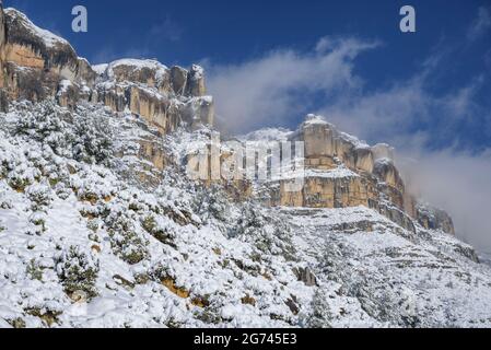 Klippen der Serra del Montsant Bergkette im Winter verschneit, von La Morera de Montsant aus gesehen (Priorat, Tarragona, Katalonien, Spanien) Stockfoto