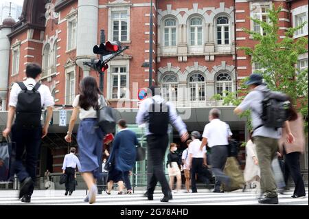 Tokio, Japan. Juli 2021. Pendler überqueren am Montag, den 12. Juli 2021, eine Straße vor dem Bahnhof Tokio in Tokio. 502 Menschen wurden in Tokio mit dem neuen Coronavirus infiziert, und Tokio trat am 12. Juli erneut in den Notstand COVID-19 ein. Quelle: Yoshio Tsunoda/AFLO/Alamy Live News Stockfoto