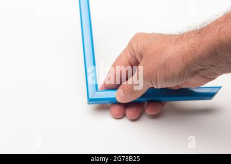 Hand, Finger und verschiedene Farben; Buntstifte, voller Bereich; farbige Winkel, die von der Hand eines Erwachsenen gehalten werden Stockfoto