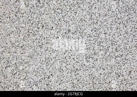 Abstrakter Hintergrund aus Granitfelsen. Natürliche dekorative mineralische strukturierte Oberfläche. Stockfoto