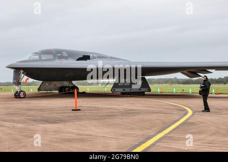 Northrop Grumman B-2 Spirit Tarnkappenbomber mit bewaffneter Sicherheit bei RAF Fairford, Royal International Air Tattoo Airshow. Bedrohliche geformte Flugzeuge. Seite Stockfoto